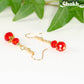 Close up of Small Red Glass Bead Dangle Earrings.