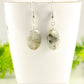 Natural Labradorite Crystal Earrings displayed on a tea cup.