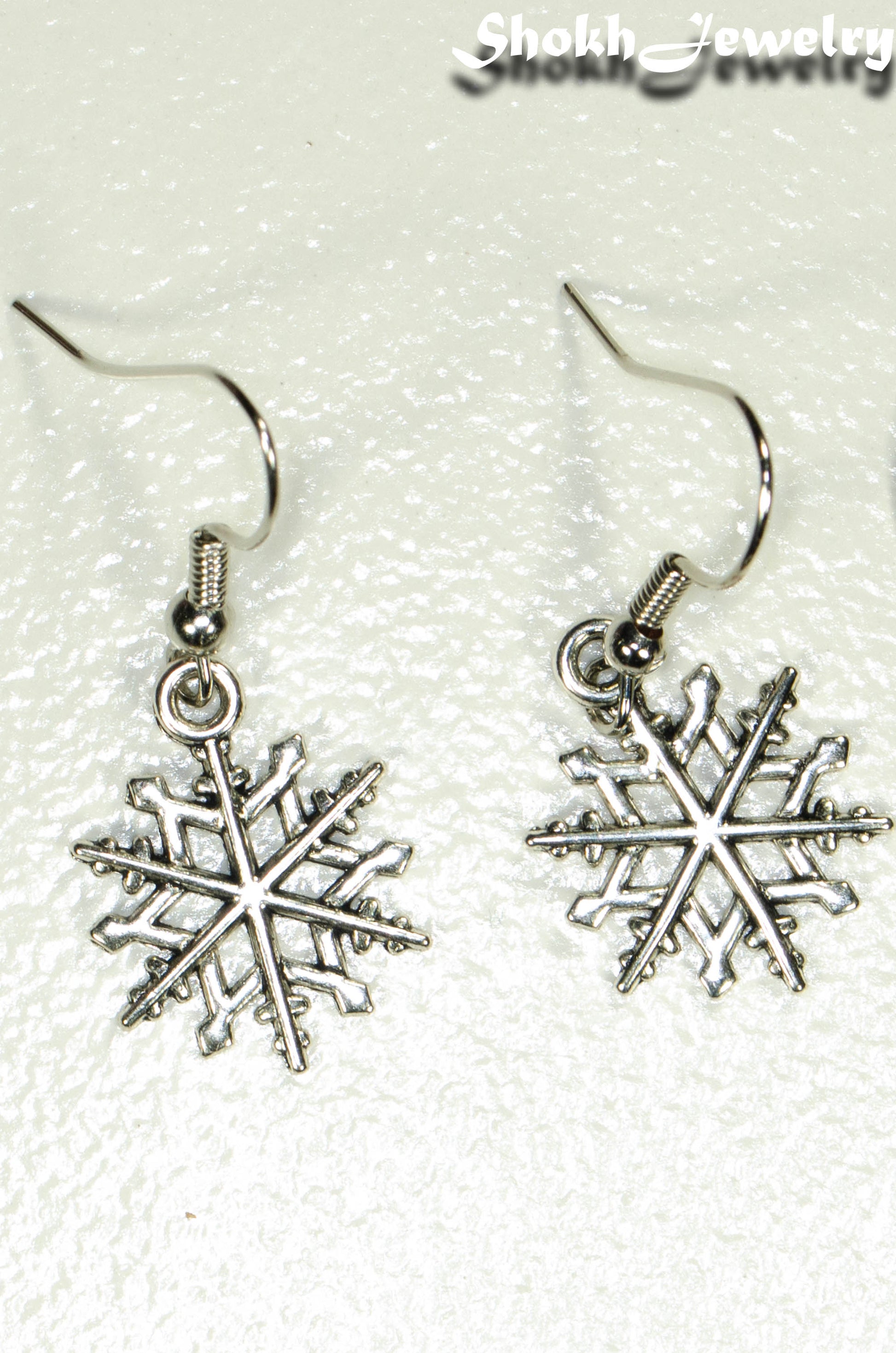 Top view of Christmas Snowflakes Charm Earrings.