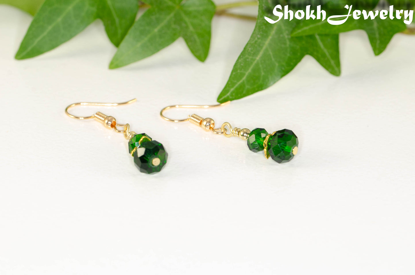 Small Dark Green Glass Bead Dangle Earrings with gold tone ear wires.