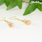 Small Light Pink Glass Bead Dangle Earrings with gold tone ear wires.