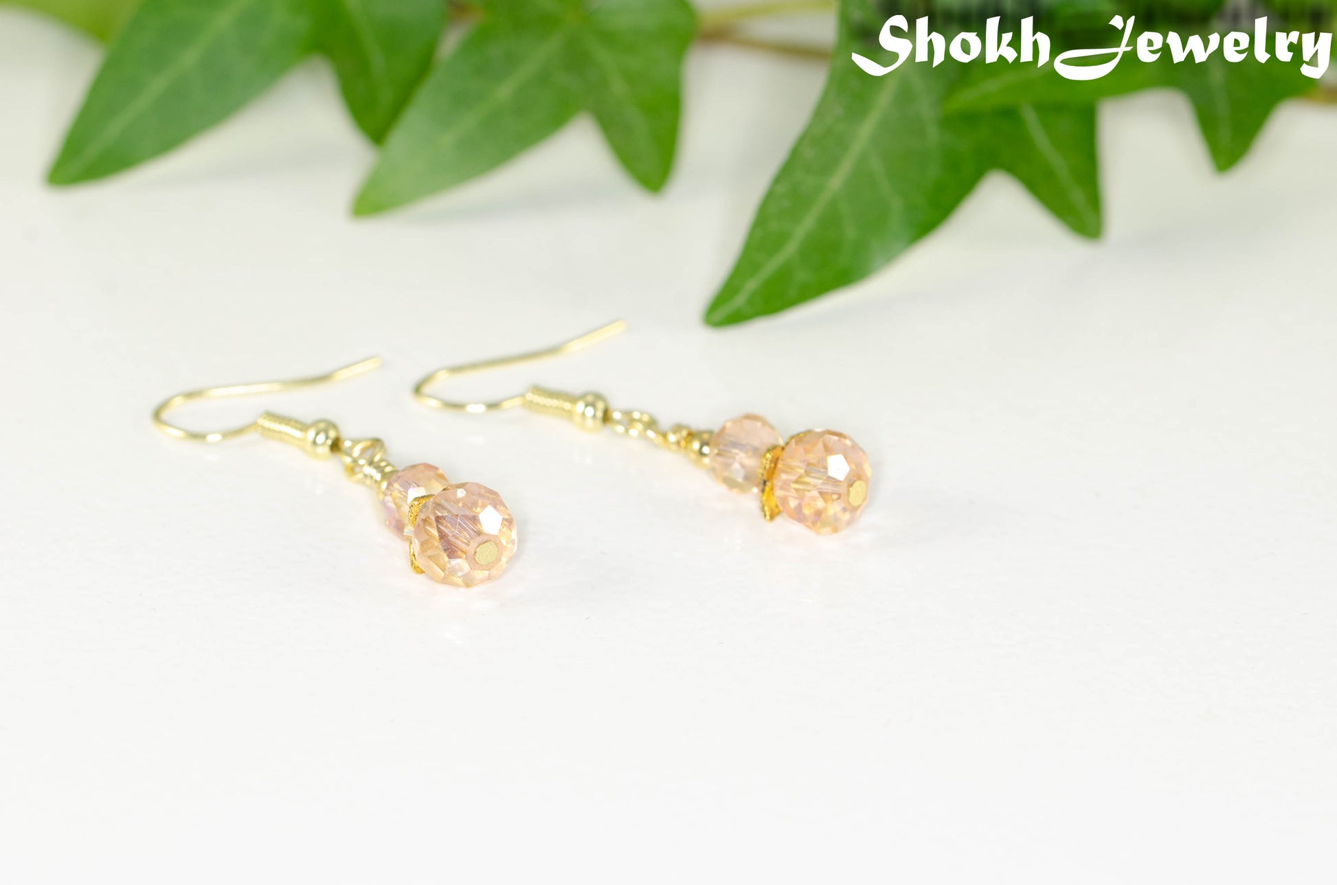 Small Light Pink Glass Bead Dangle Earrings with gold tone ear wires.