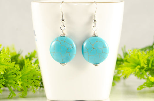 20mm Turquoise Howlite Earrings displayed on a tea cup.