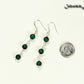 Long Genuine Malachite Dangle Earrings beside a dime.