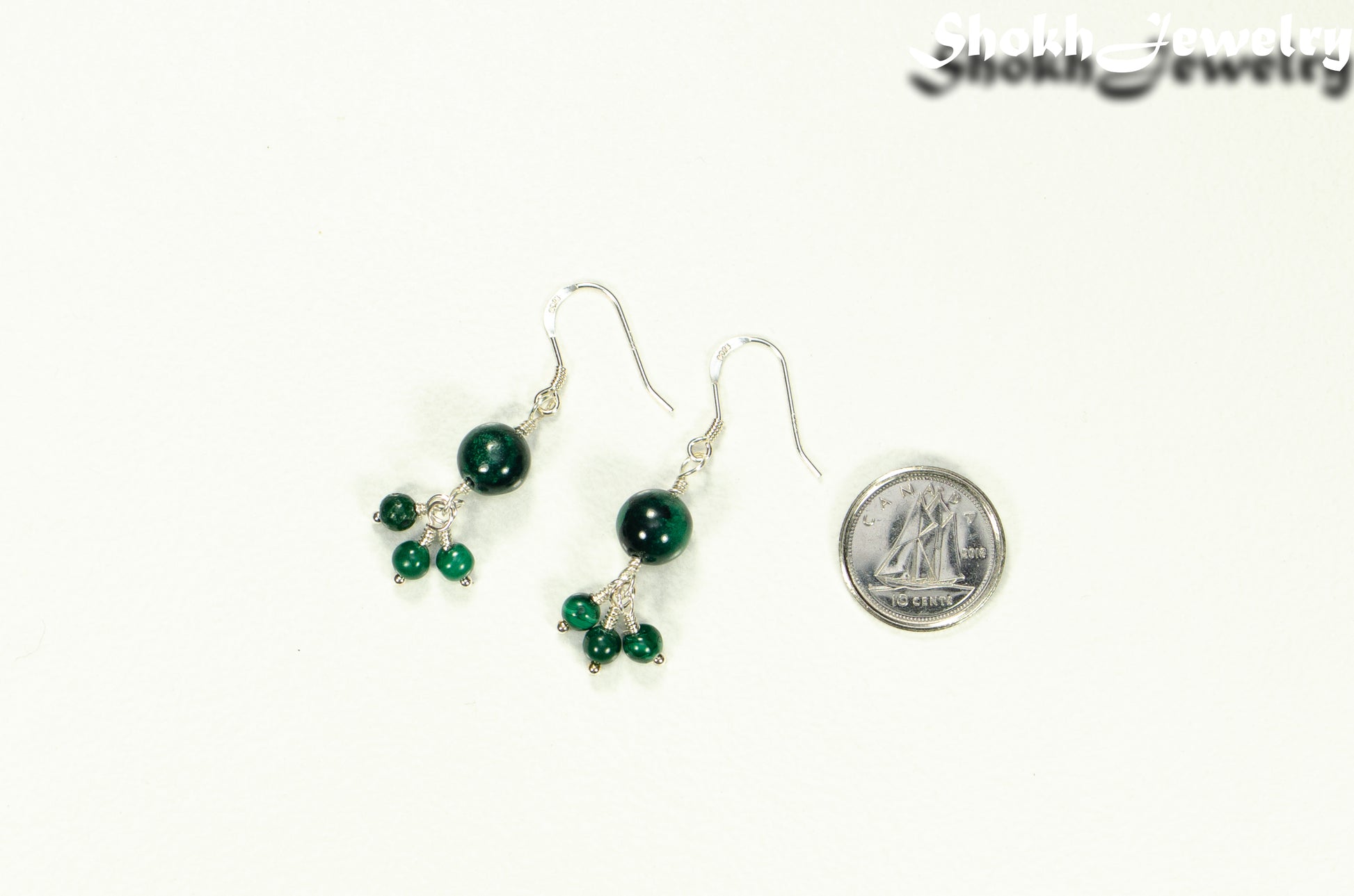 Genuine Malachite Dangle Earrings beside a dime.