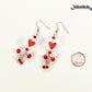 Statement Red Heart Ceramic Bead Earrings beside a dime.