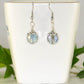 10mm Glass Crystal Disco Ball Earrings displayed on a tea cup.