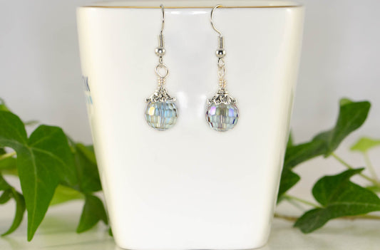 10mm Glass Crystal Disco Ball Earrings displayed on a tea cup.