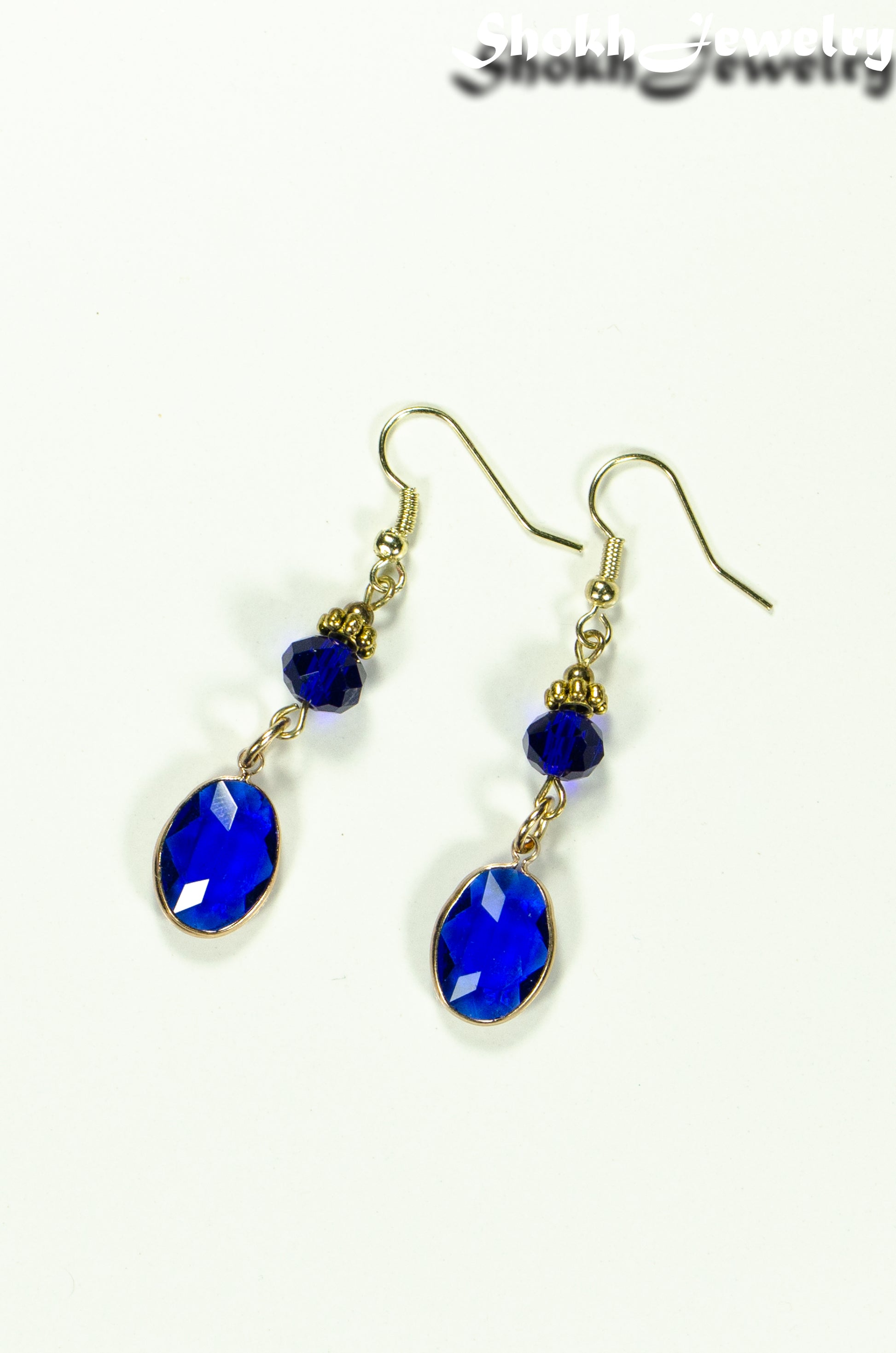 Top view of Navy Blue Oval Glass Dangle Earrings.