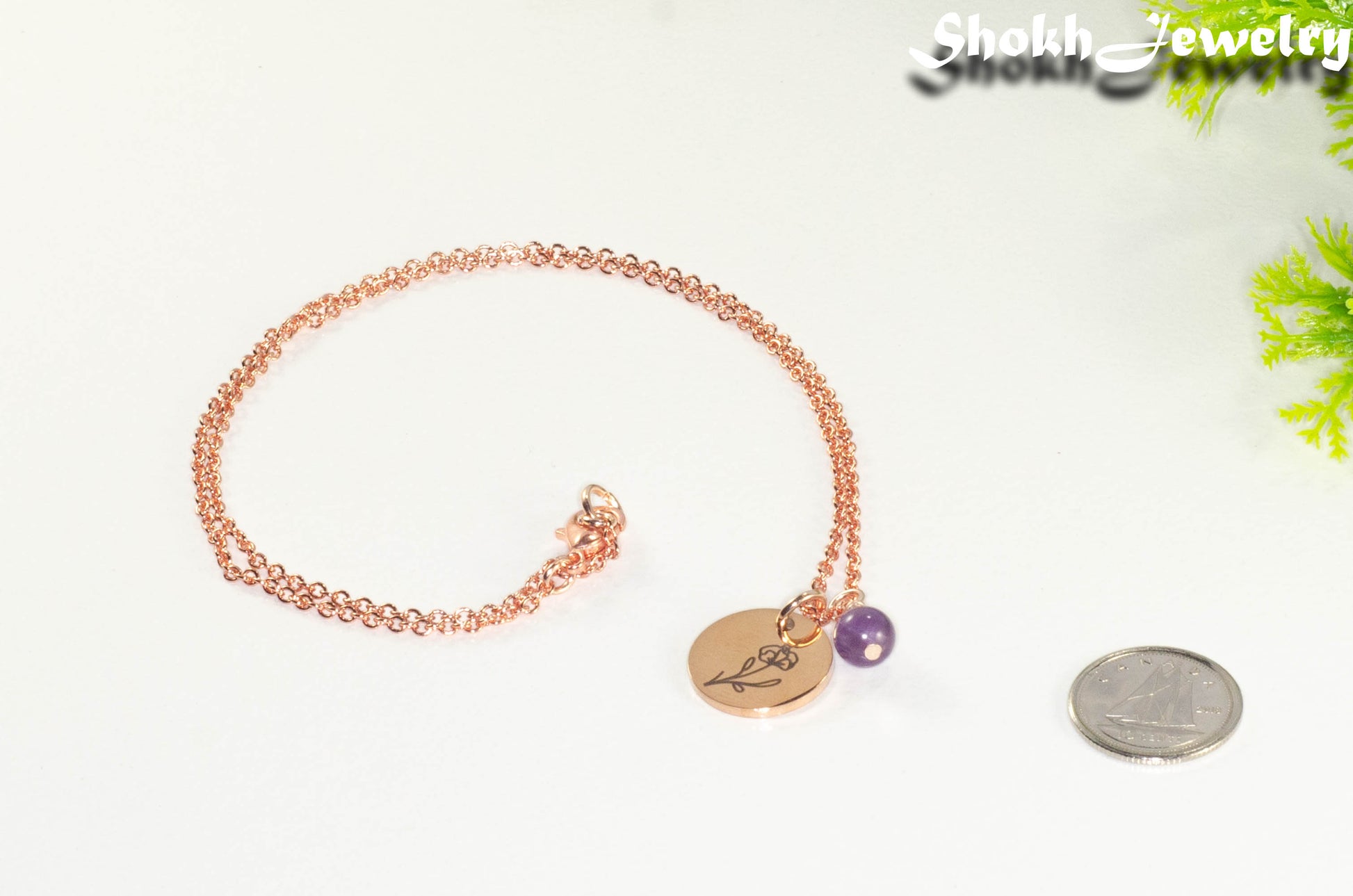 Rose Gold Plated February Birth Flower Necklace with Amethyst Birthstone Pendant beside a dime.