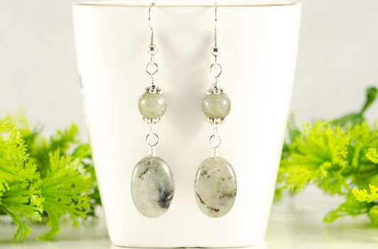 Statement Labradorite Crystal Earrings displayed on a tea cup.