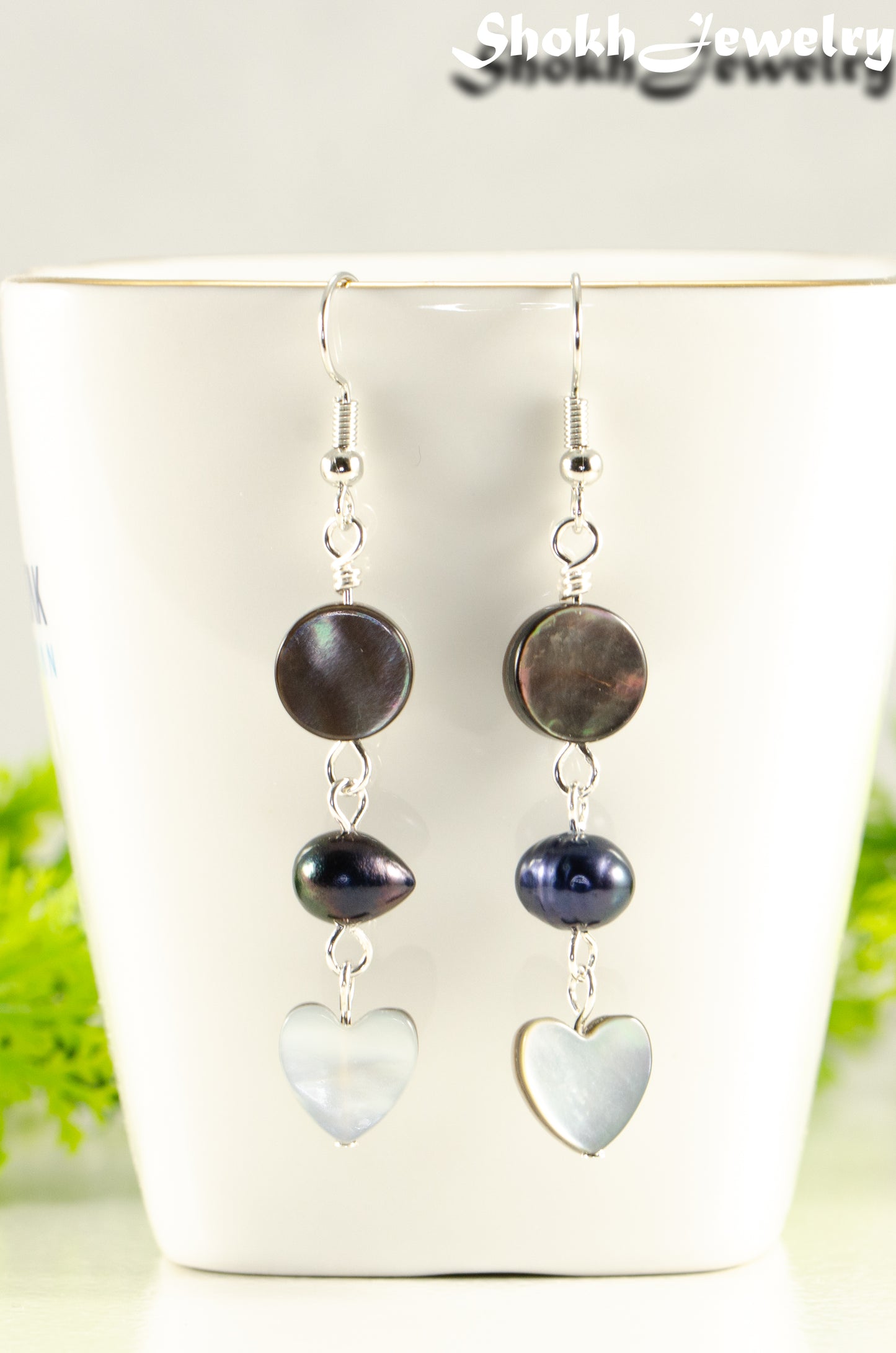 Close up of Grey Seashell and Black Pearl Earrings.
