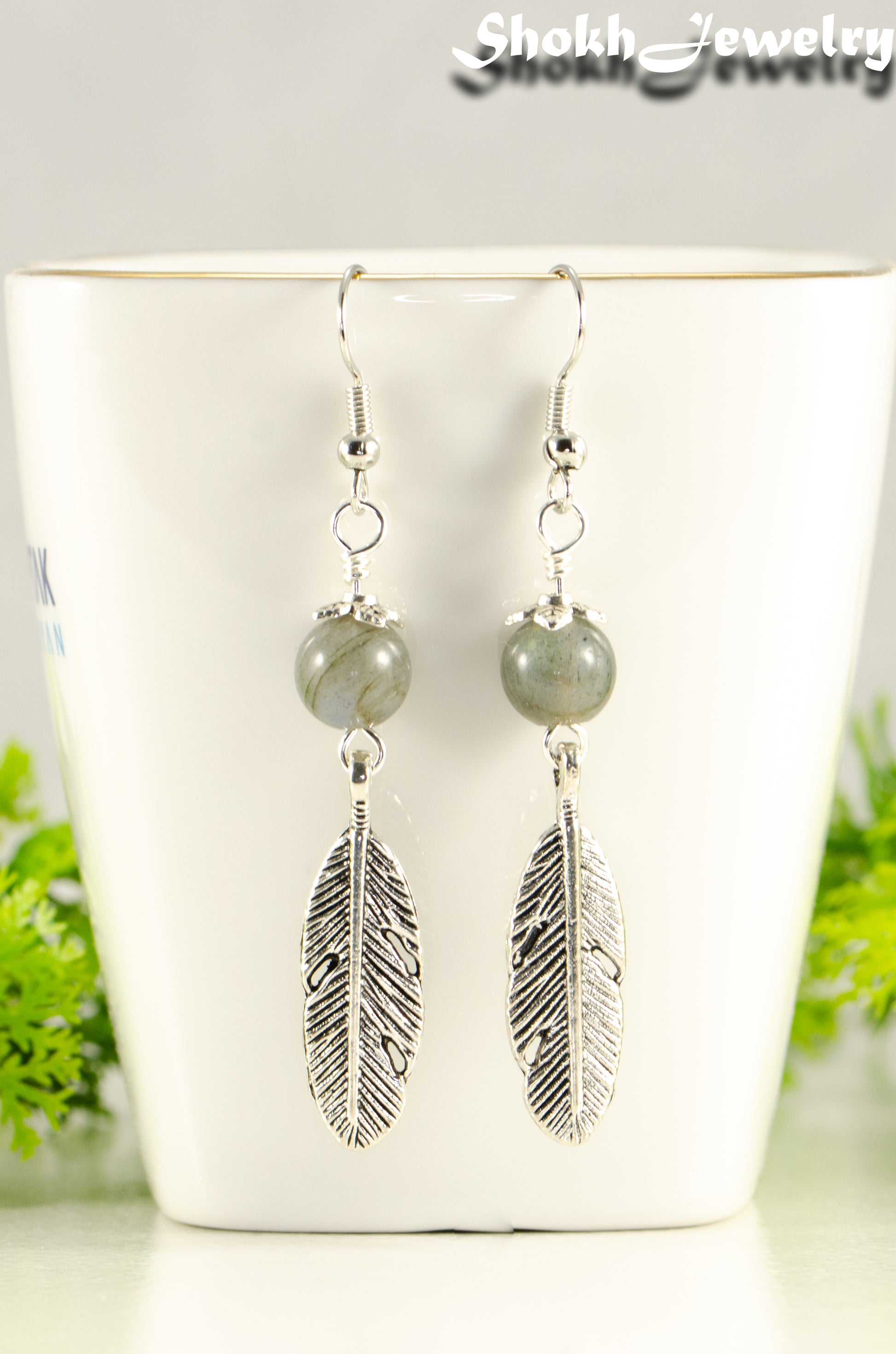 Close up of Labradorite Crystal and Tibetan Silver Feather Earrings.