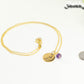 Gold Plated February Birth Flower Necklace with Amethyst Birthstone Pendant beside a dime.