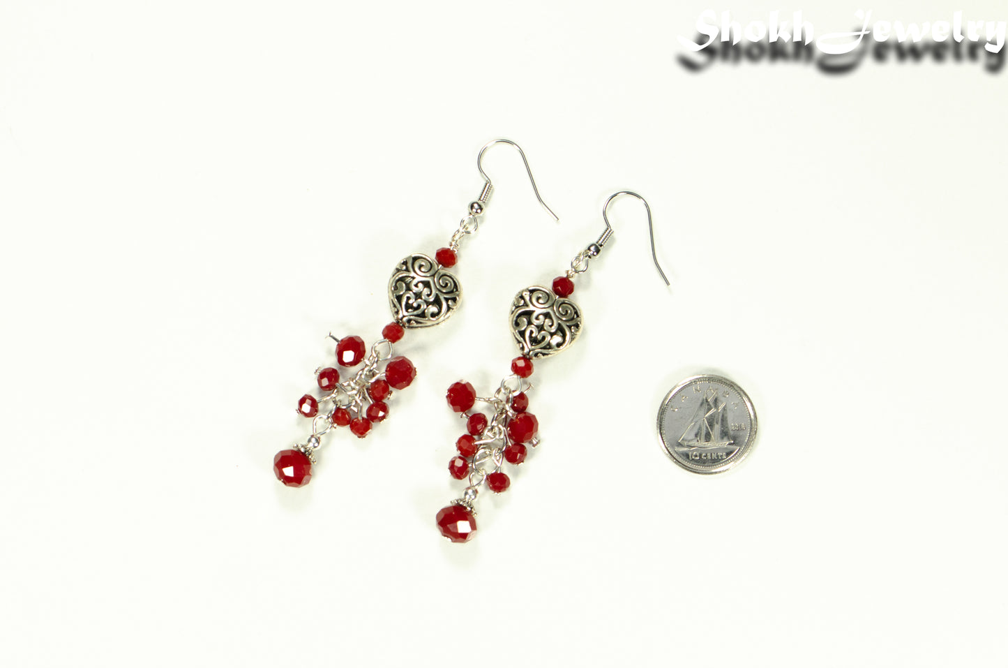 Tibetan Silver Heart and Red Beaded Cluster Earrings beside a dime.