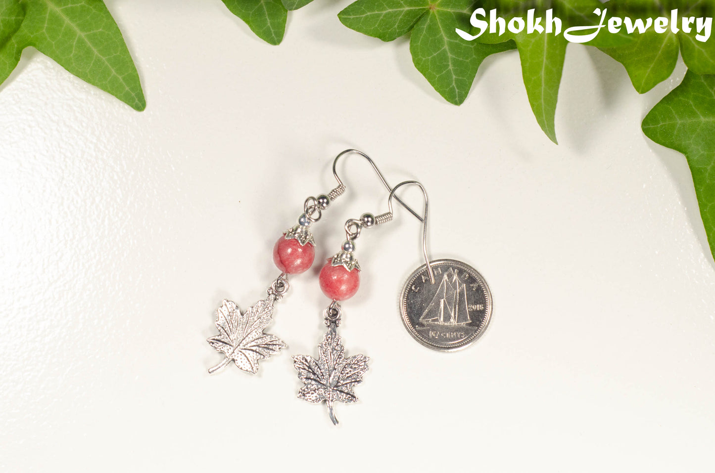 Red Quartzite and Tibetan Silver Maple Leaf Dangle Earrings beside a dime.