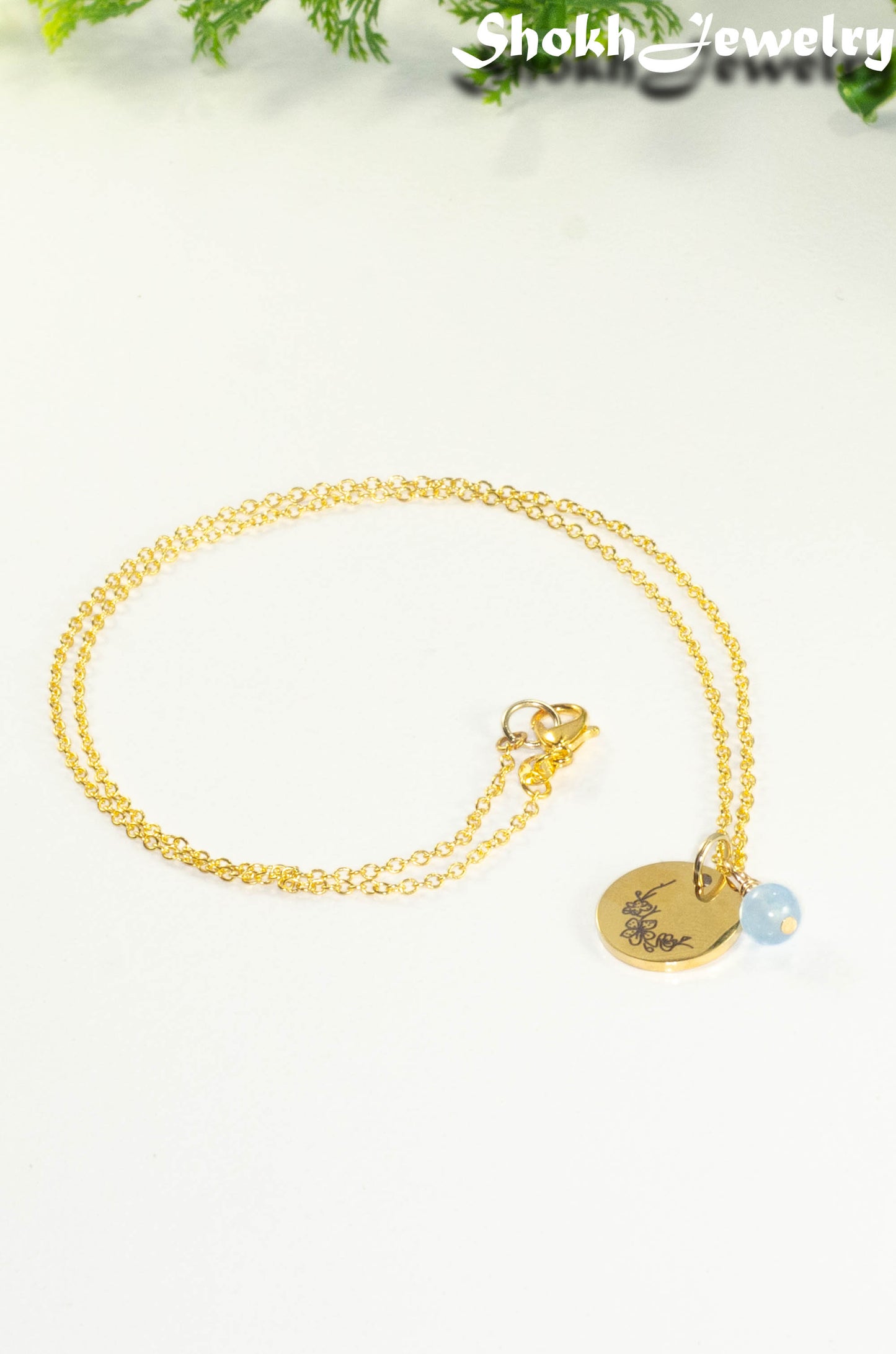 Gold Plated March Birth Flower Necklace with Aquamarine Birthstone Pendant.