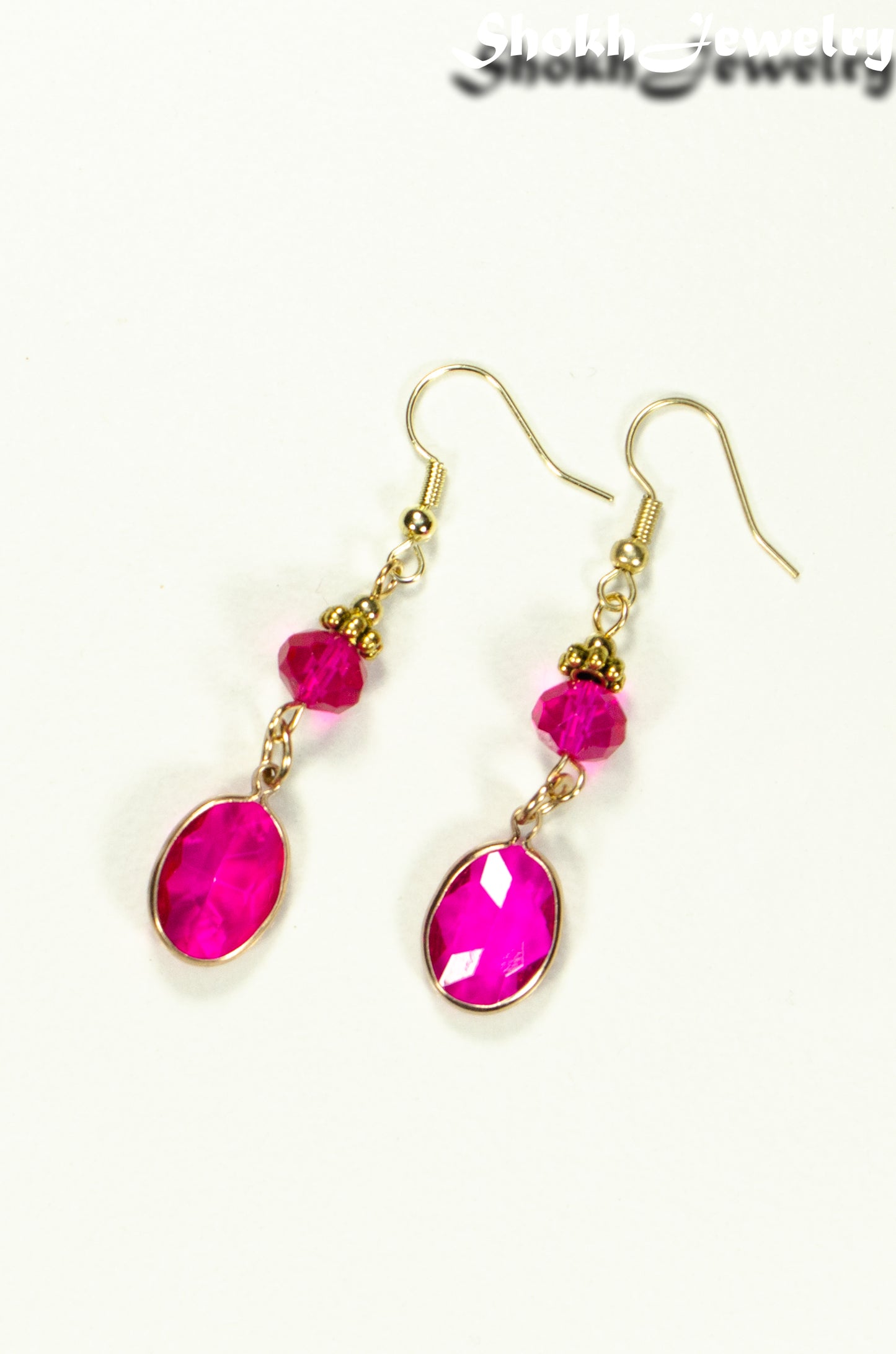 Top view of Hot Pink Oval Glass Dangle Earrings.