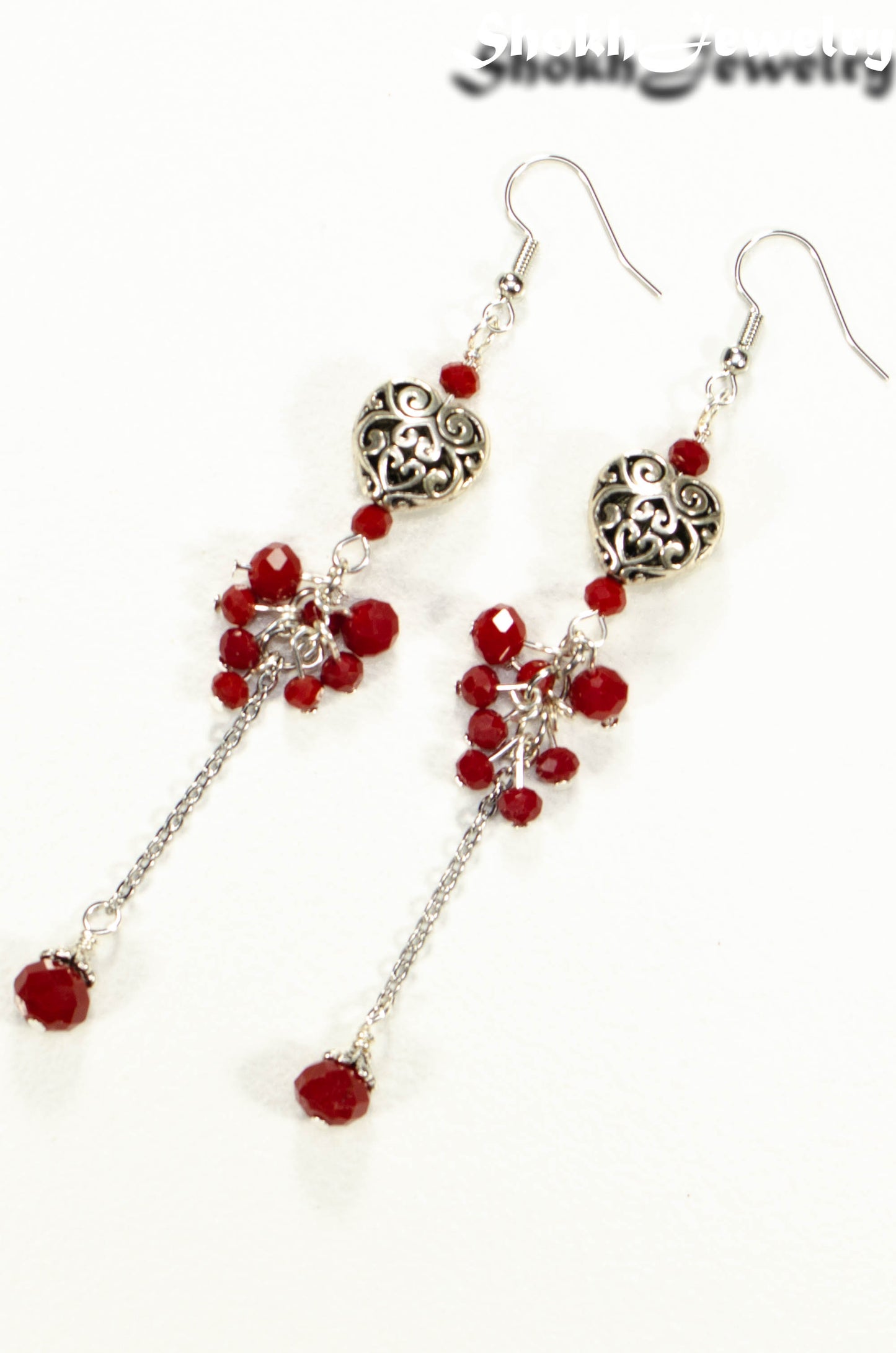 Top view of Statement Tibetan Silver Heart and Red Beaded Cluster Earrings.