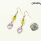 Light Yellow Oval Glass Dangle Earrings beside a dime.