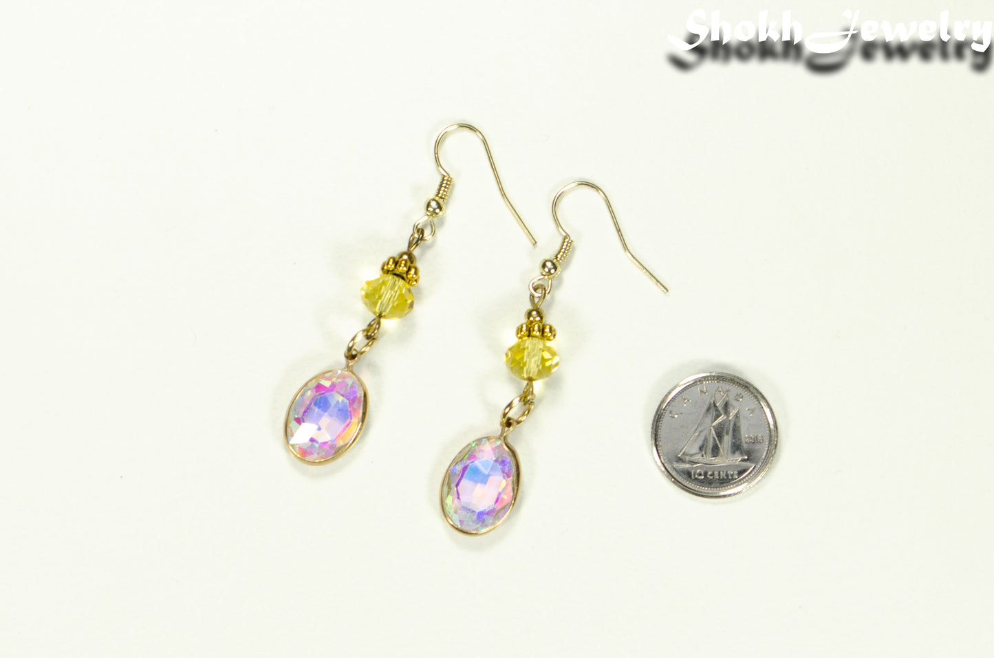 Light Yellow Oval Glass Dangle Earrings beside a dime.