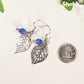 Filigree Silver Leaf Charm and Blue Glass Crystal Earrings beside a dime.