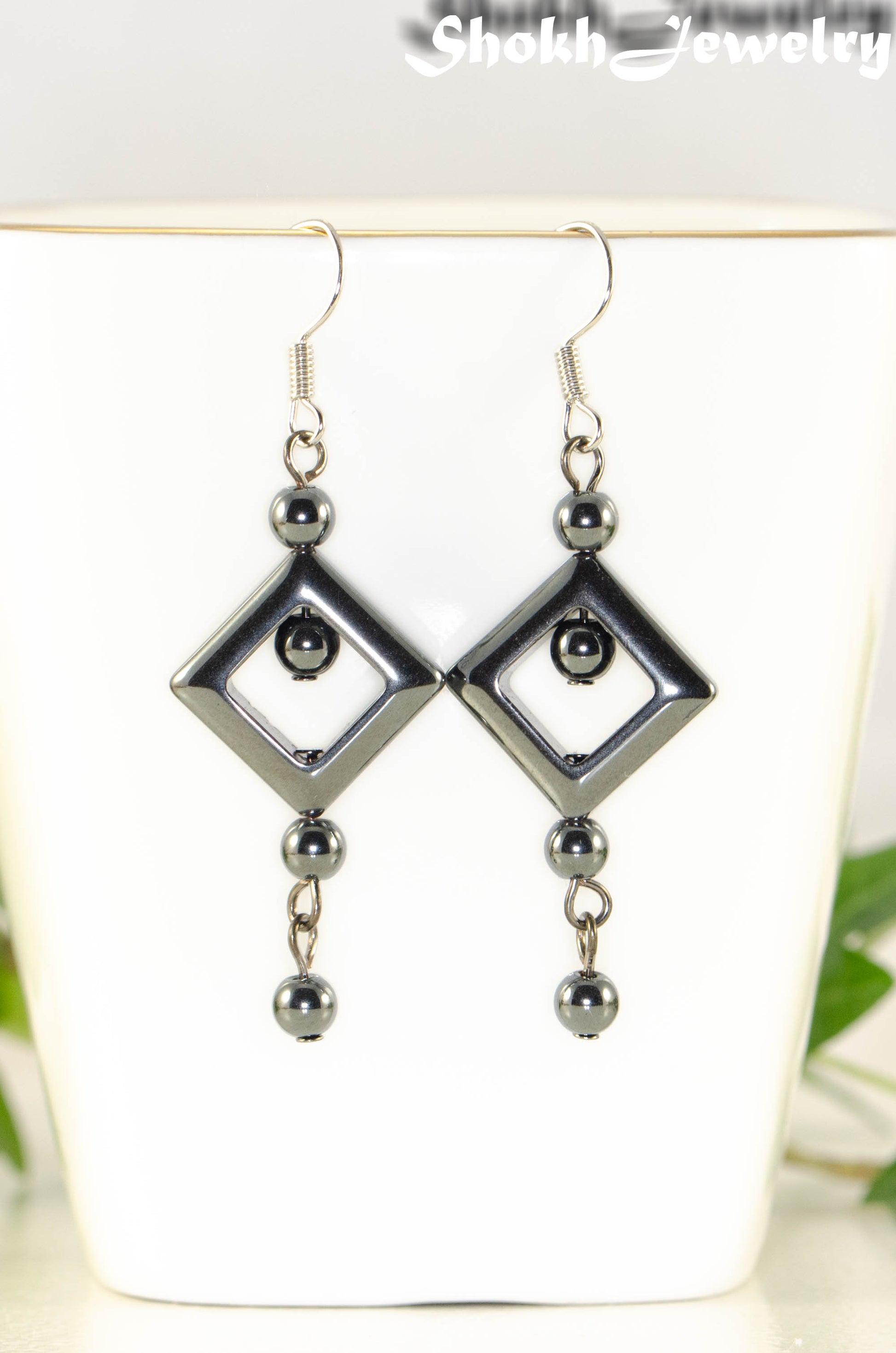 Close up of Long Black Hematite Geometric Earrings.