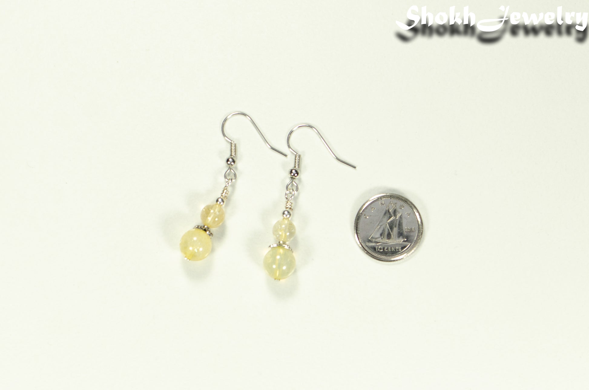 Small Natural Citrine Crystal Earrings beside a dime.