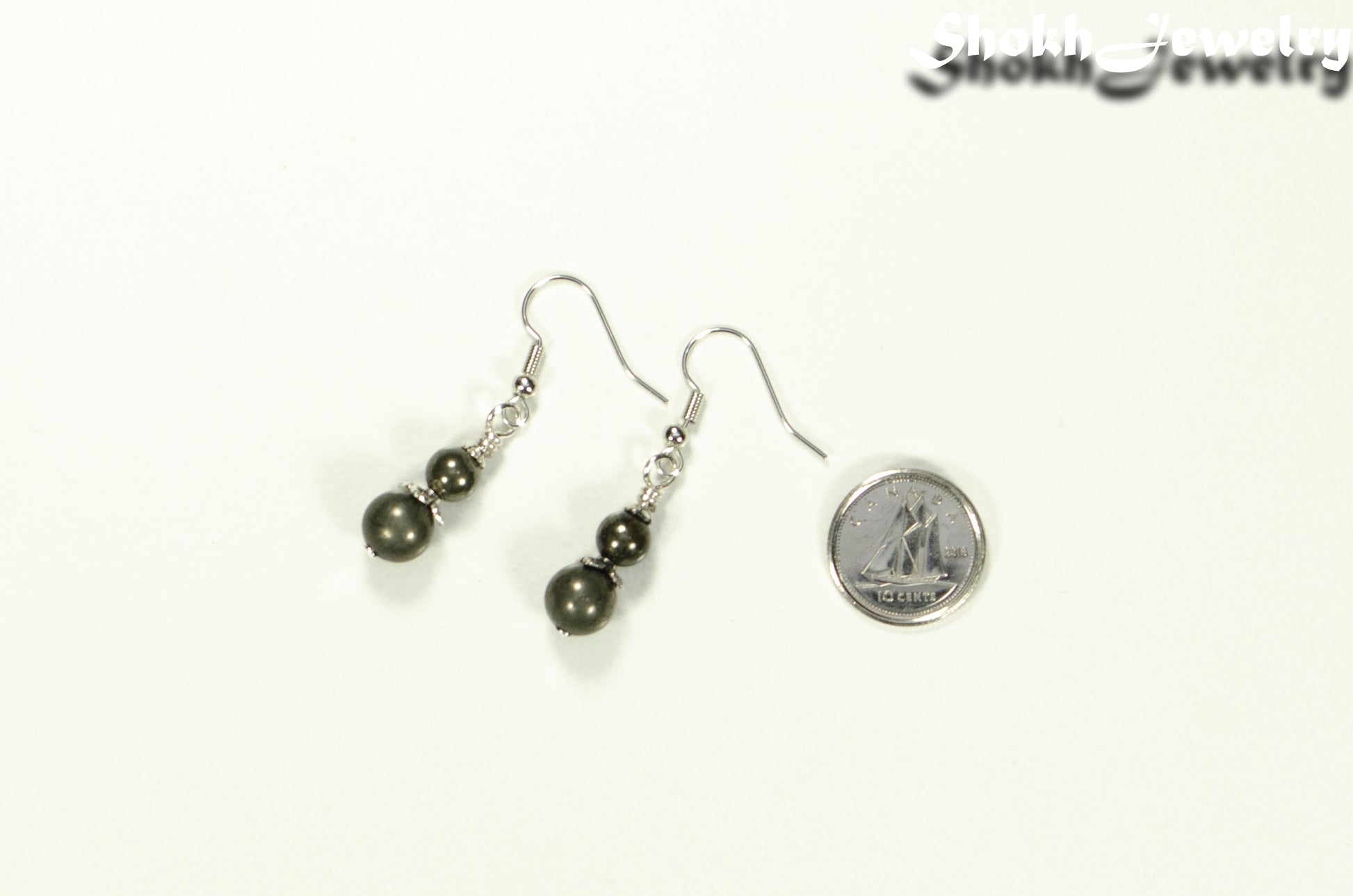 Small Natural Pyrite Earrings beside a dime.