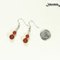 Small Matte Red Agate Earrings beside a dime.