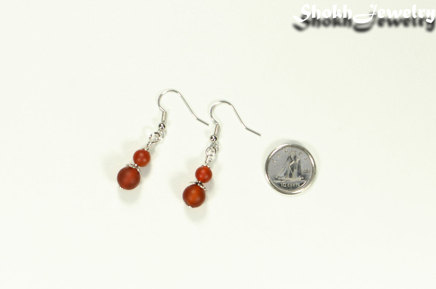 Small Matte Red Agate Earrings beside a dime.