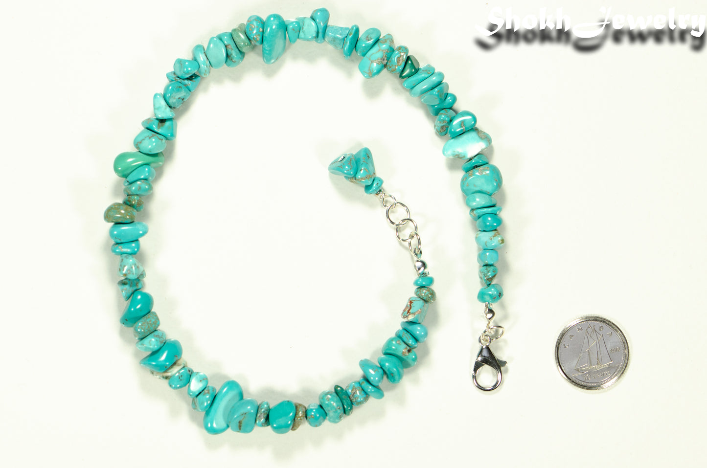 Natural Turquoise Crystal Chip Anklet beside a dime.