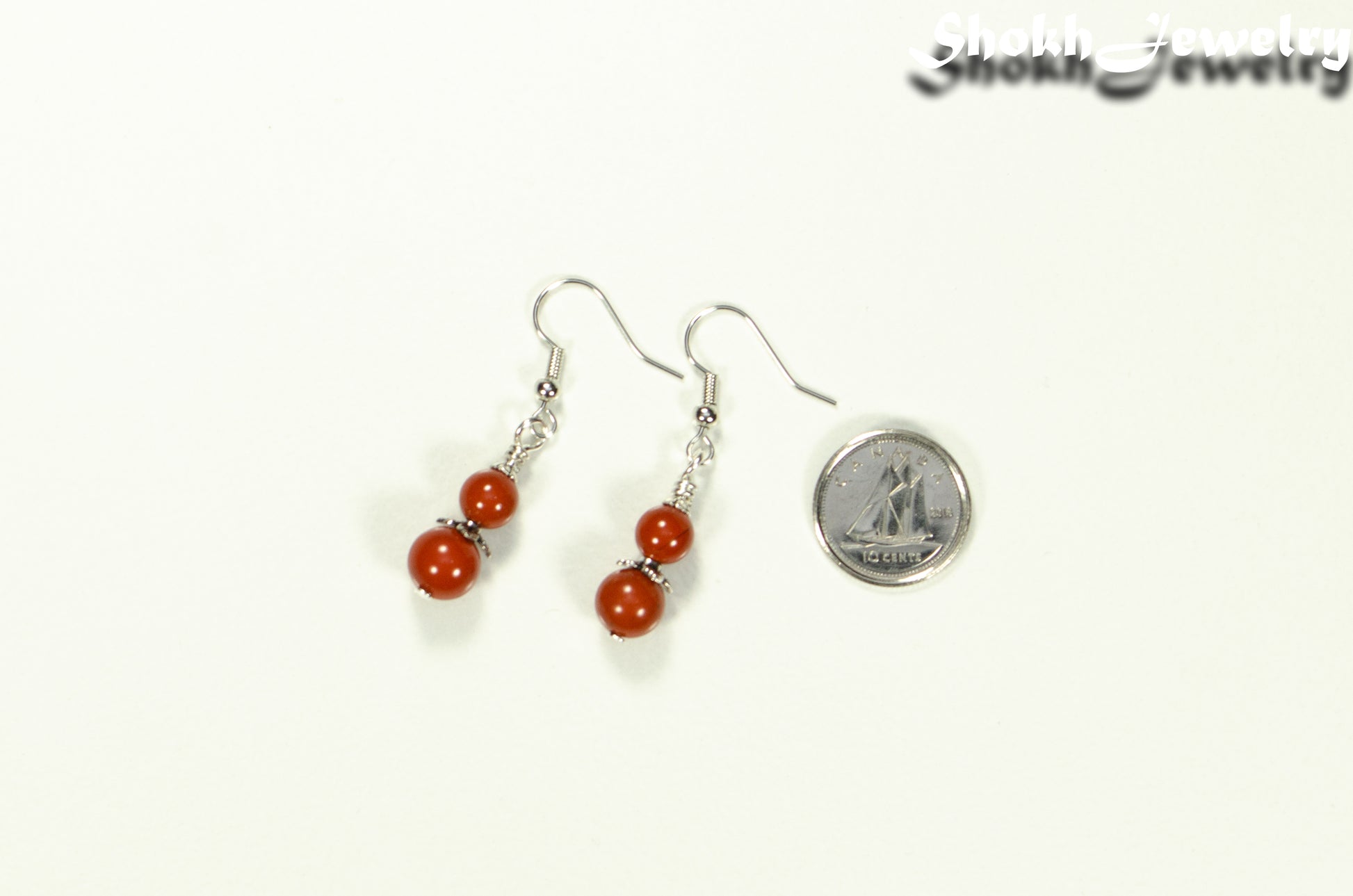 Small Natural Red Jasper Earrings beside a dime.