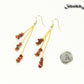 Long Gold Plated Chain and Red Jasper Chip Earrings beside a dime.