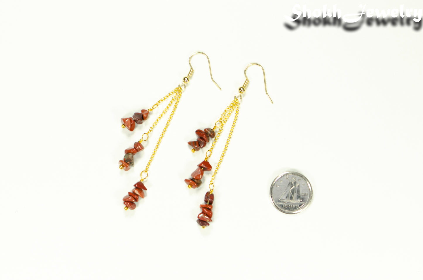 Long Gold Plated Chain and Red Jasper Chip Earrings beside a dime.