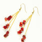 Top view of Long Gold Plated Chain and Red Dyed Bamboo Coral Chip Earrings.