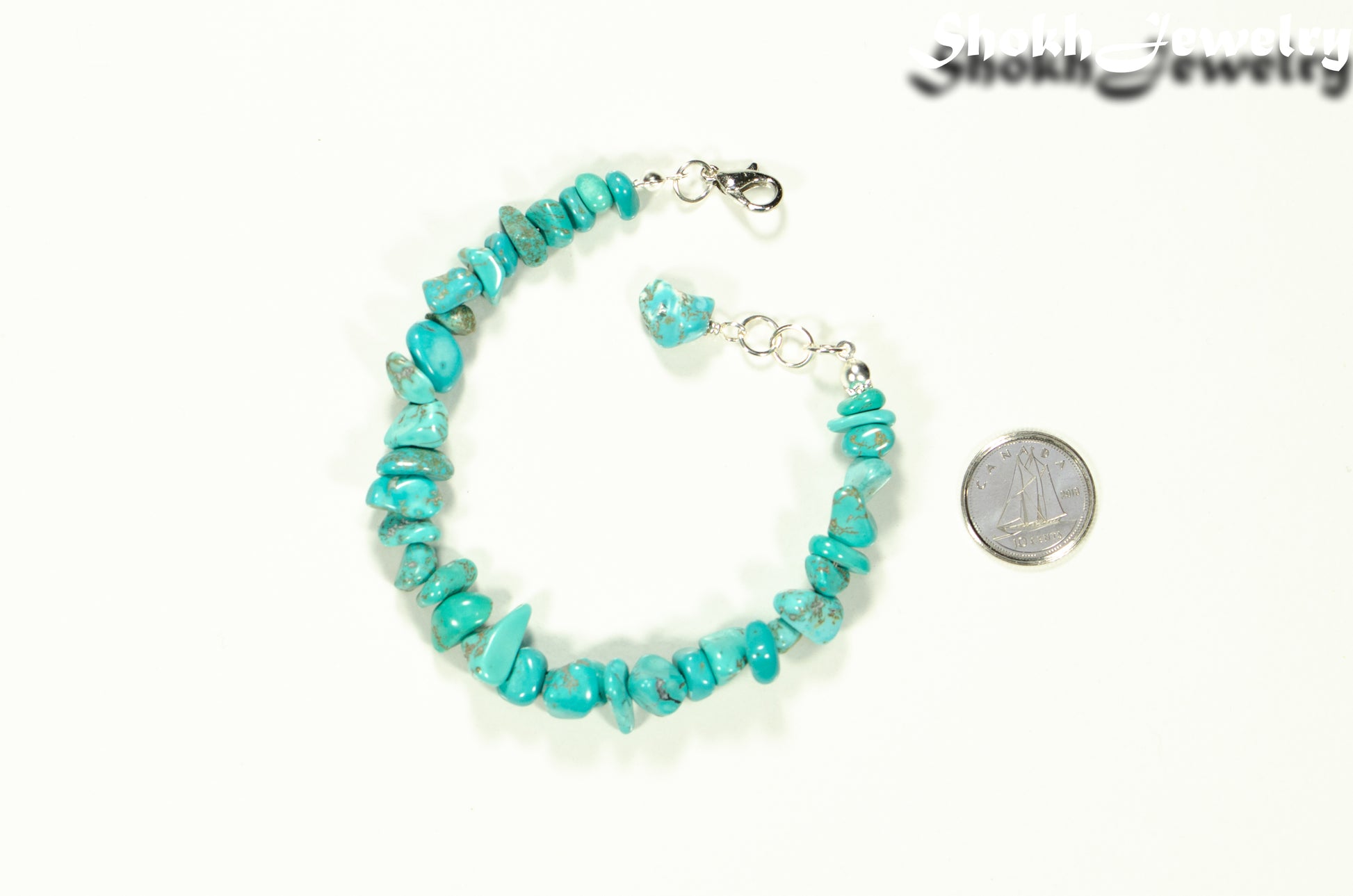 Natural Turquoise Crystal Chip Bracelet beside a dime.