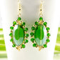 Close up of Oval Green Glass Crystal Wire Wrapped Earrings.