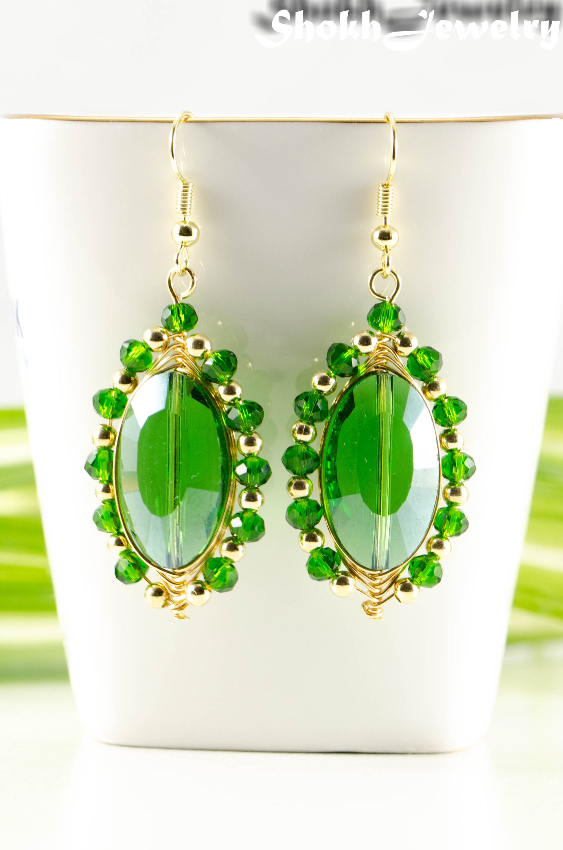 Close up of Oval Green Glass Crystal Wire Wrapped Earrings.