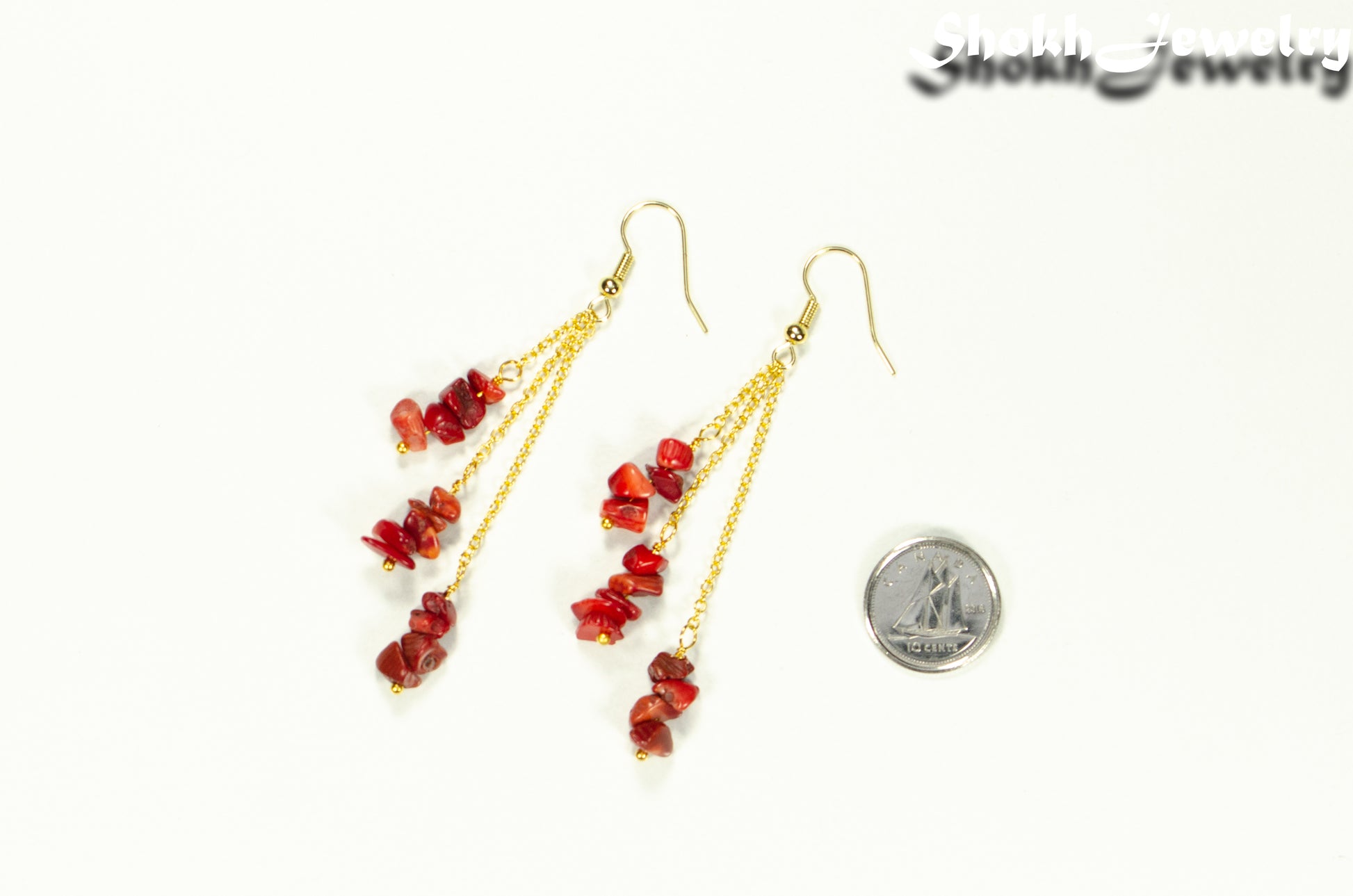 Long Gold Plated Chain and Red Dyed Bamboo Coral Chip Earrings beside a dime.
