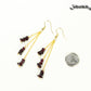 Long Gold Plated Chain and Garnet Crystal Chip Earrings beside a dime.