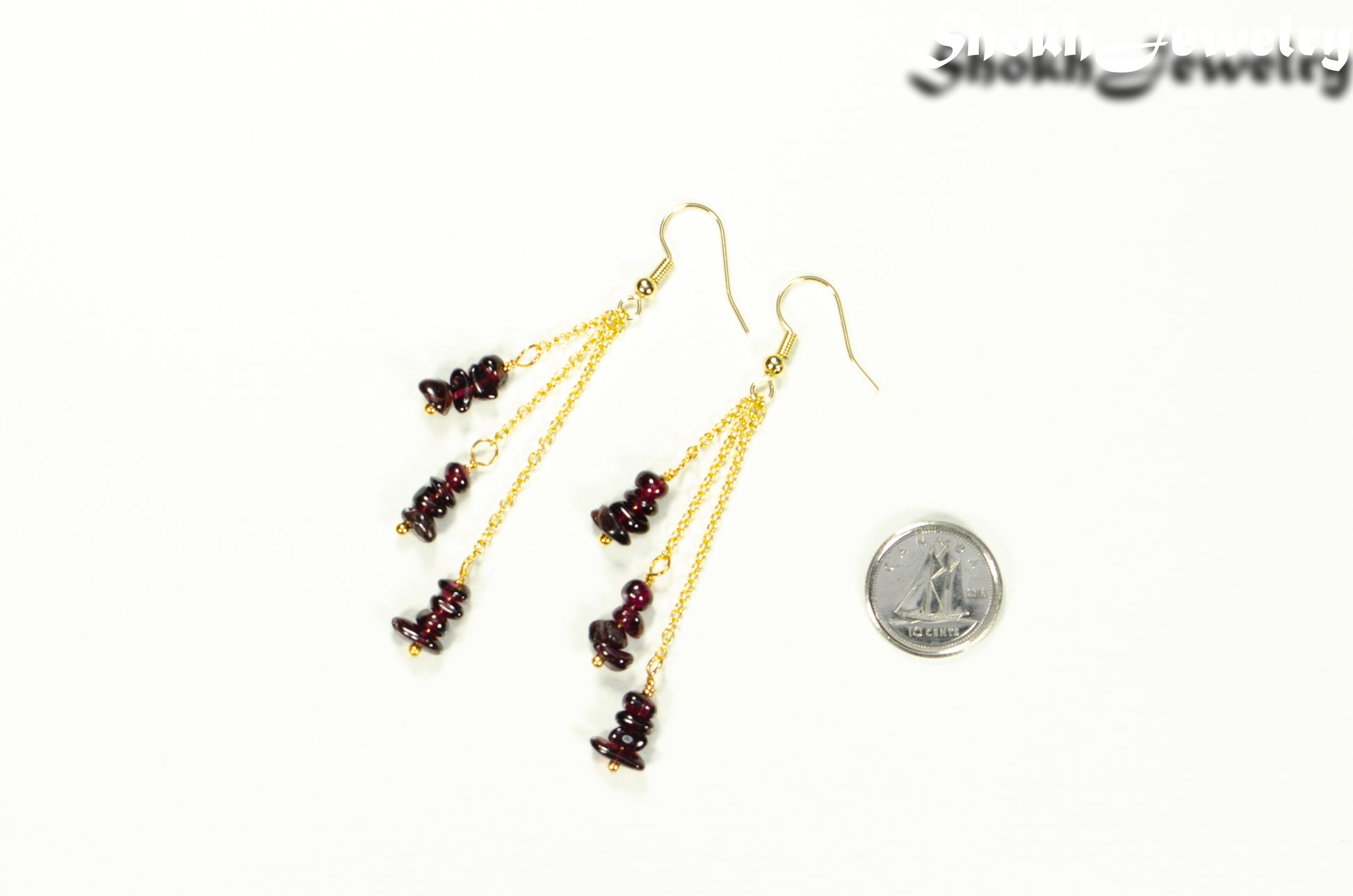 Long Gold Plated Chain and Garnet Crystal Chip Earrings beside a dime.