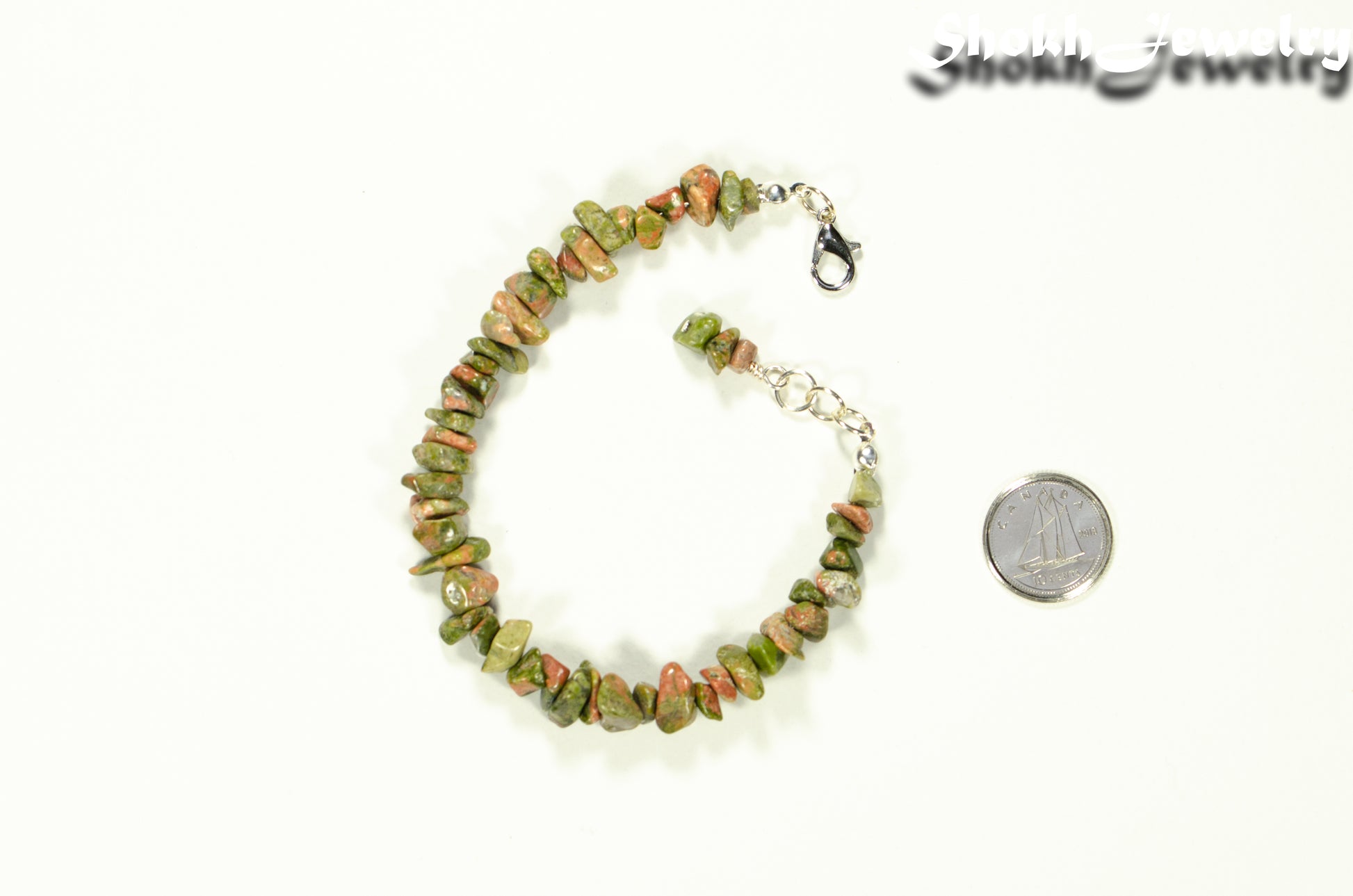 Natural Unakite Crystal Chip Bracelet beside a dime.