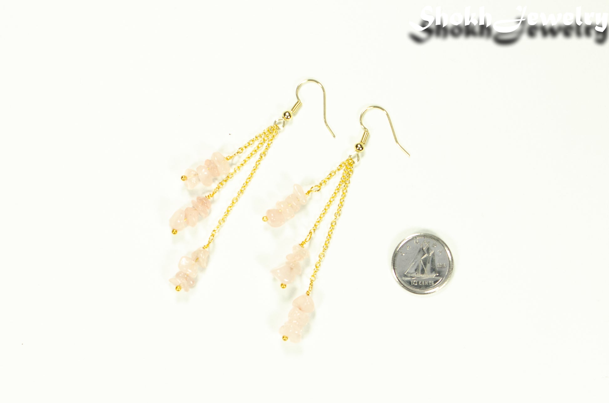 Long Gold Plated Chain and Rose Quartz Crystal Chip Earrings beside a dime.