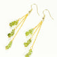 Top view of Long Gold Plated Chain and Peridot Chip Earrings.