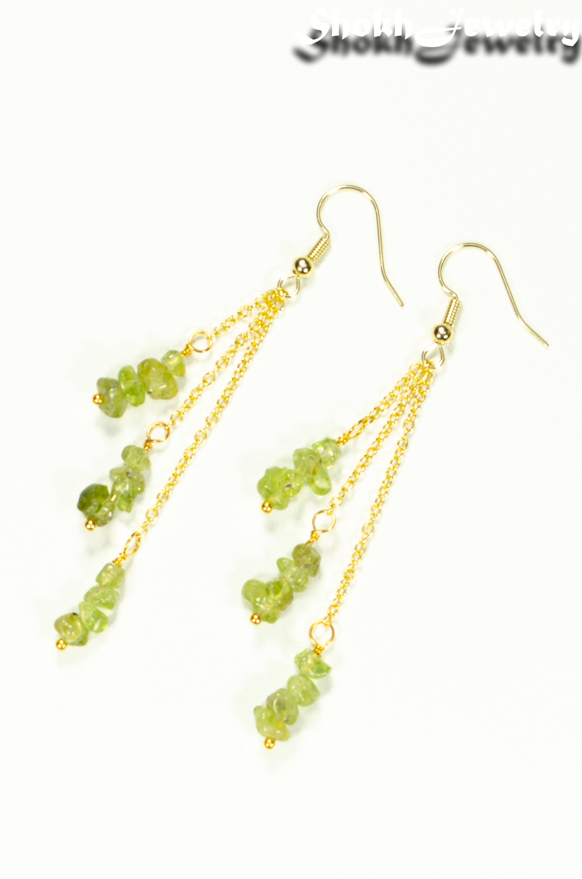 Top view of Long Gold Plated Chain and Peridot Chip Earrings.