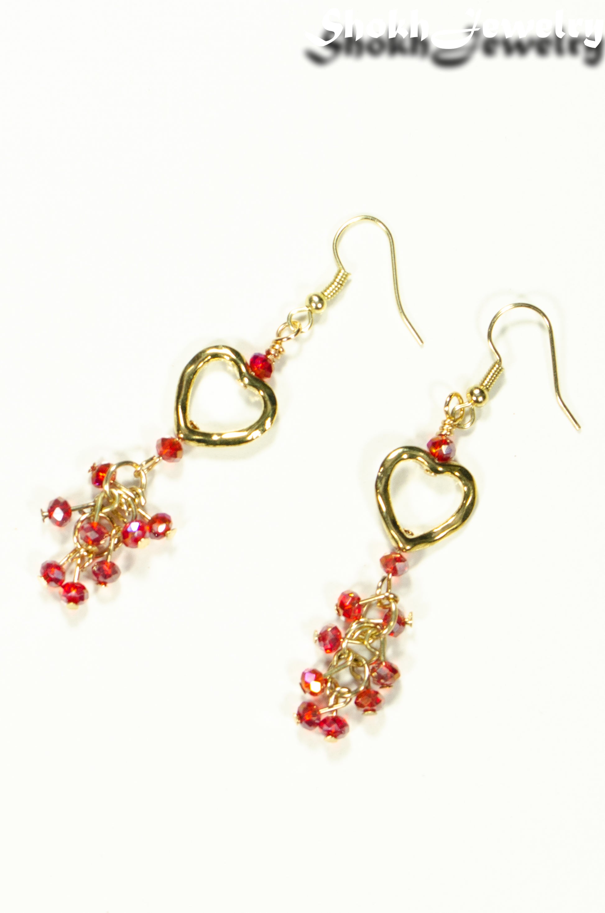 Top view of Gold Plated Heart and Red Crystal Cluster Earrings.