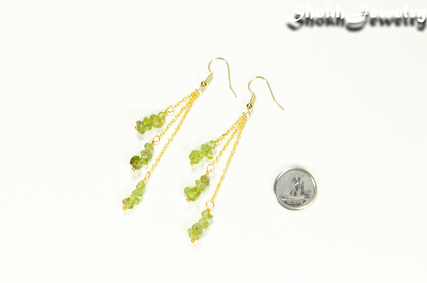 Long Gold Plated Chain and Peridot Chip Earrings beside a dime.