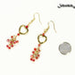 Gold Plated Heart and Red Crystal Cluster Earrings beside a dime.