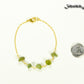 Peridot Crystal Chip and Gold Plated Chain Bracelet beside a dime.